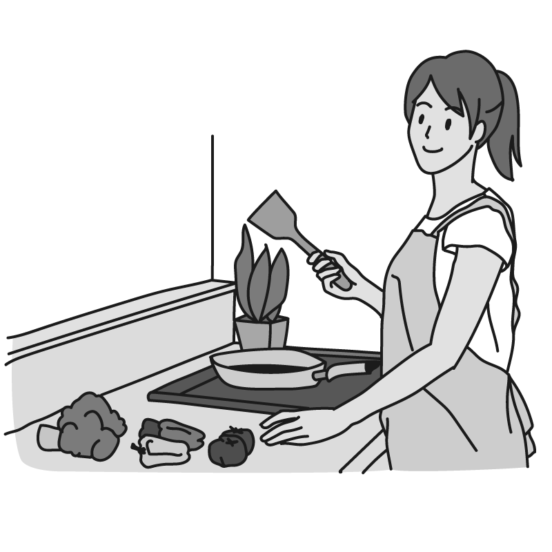 調理を始める女性（モノクロ）