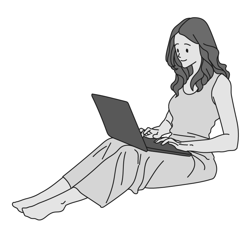 座ってノートパソコンを操作する女性（モノクロ）
